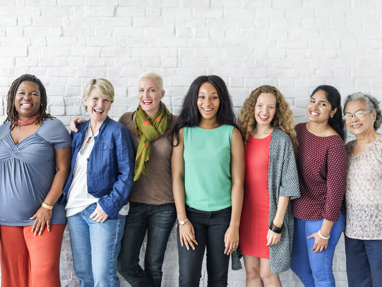 a diverse array of women smiling