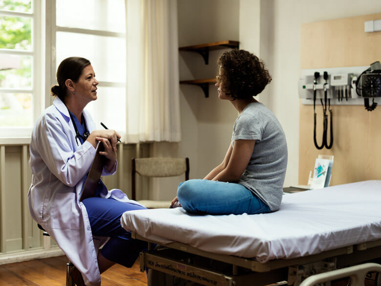 doctor talking to a female teenager
