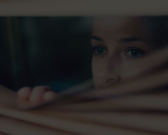 woman looking through window
