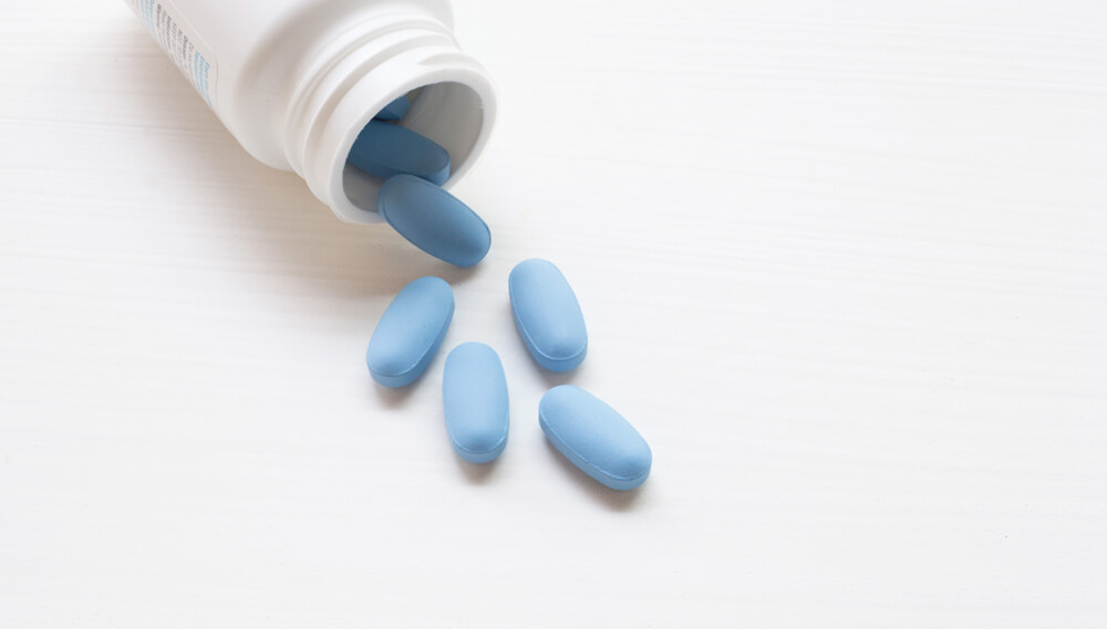 Pills spilling out of a bottle.