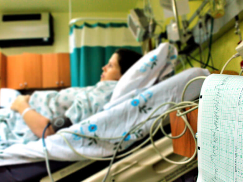pregnant woman in hospital bed and medical equipment
