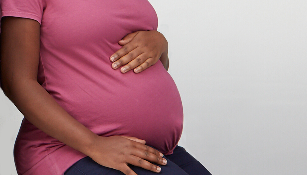 Pregnant women holding her belly.