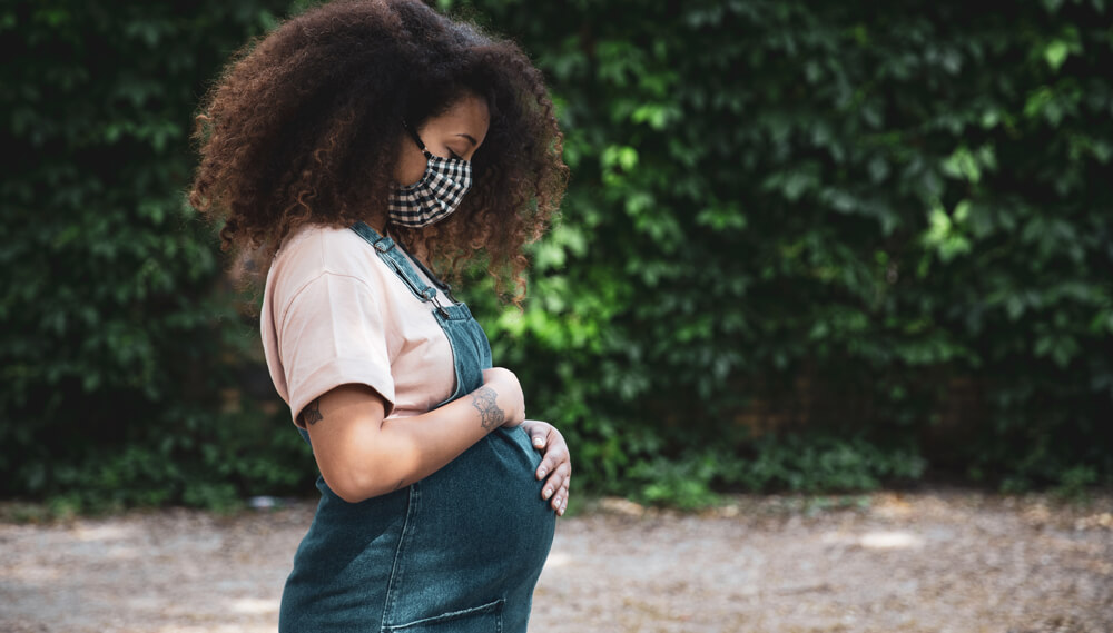 Pregnant woman wearing a face covering.