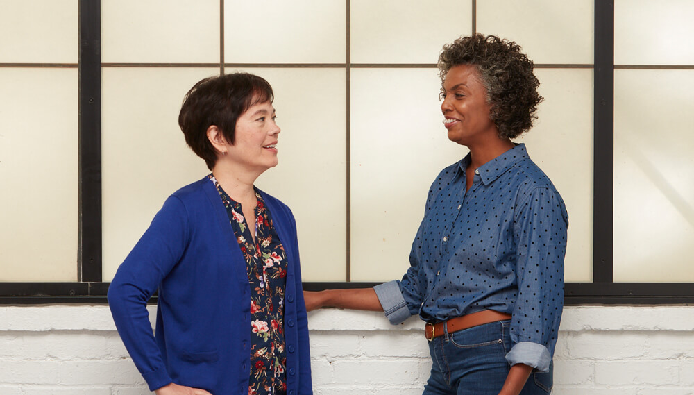 Two middle-aged women talking.