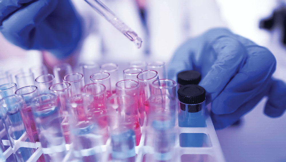 Lab worker holding test tubes.