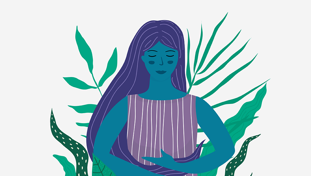 Woman standing among leaves.